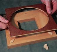 Make the cutout with a scroll or jig saw, then use a drum sander to clean up the edges.