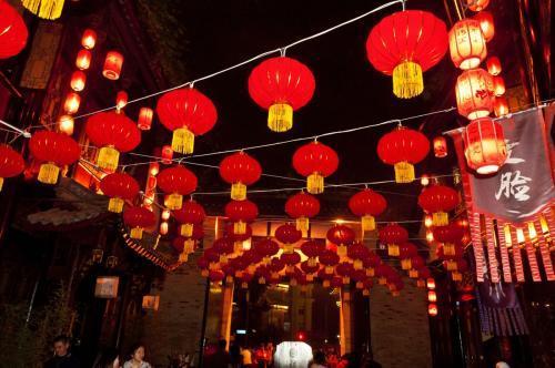 People hang red lanterns in