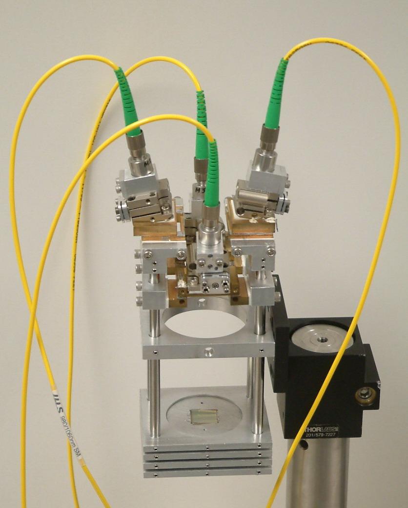 combiner with actual size 18x7x6 cm 3 and performance similar to linear table-top SBC systems has been developed (Fig. 4.5). Figure 4.5. Multi-channel monolithic high-spectral-density beam combiner.