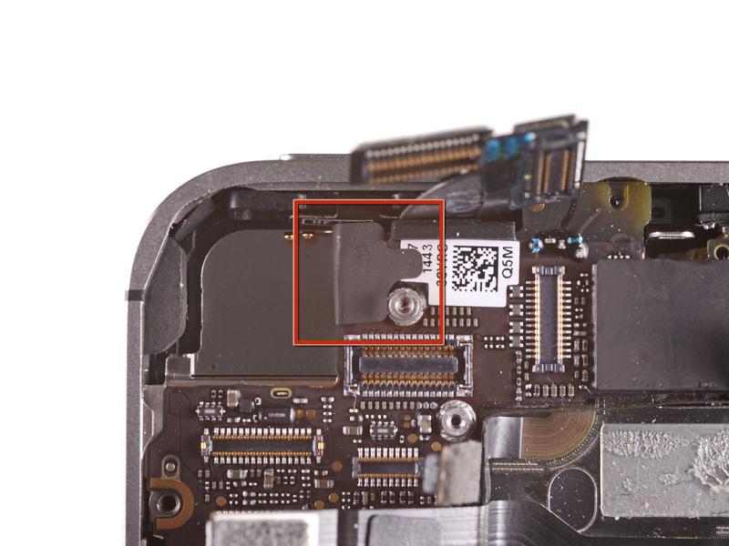Step 22 If present, peel the piece of black tape covering the hidden screw near the power button. Remove the 2.6 mm Phillips screw securing the logic board near the power button.