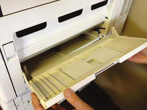 To prepare the printer for the HD-CXENVL-FDR envelope feeder, you must first remove the door from the Multi-Purpose Tray (MP Tray).