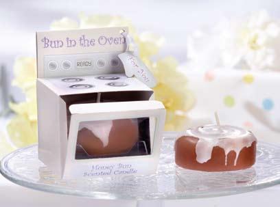 KA14049NA 3. Bun in the Oven Scented Candle (Set of 4) Cinnamon-scented, cinnamon bun-shaped candle sits in cardboard oven.