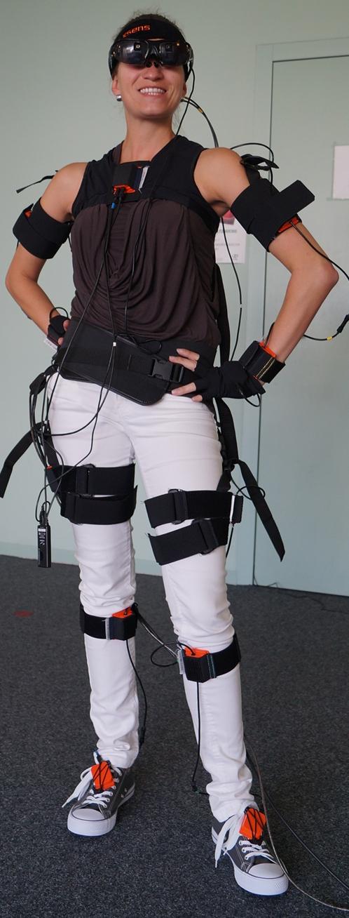 Figure 1: User wearing the proposed AR setup consisting of an inertial motion capturing suit and see-through HMD. communication gap between users and computers.