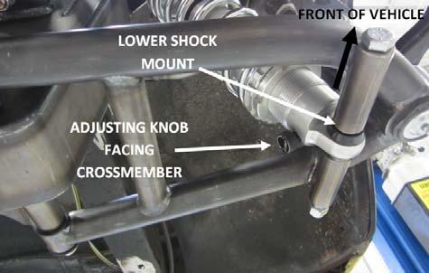 The adjusting knob will distinguish the bottom of the shock. Make sure that the adjusting knob is facing the crossmember.