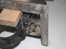 I used two clean and true boards, a narrow (3/4" x 1" x 18") one placed on top of the subframe and a wider (3/4" x 2-3/8" x 18") one to clear the subframe swing arm mountings.