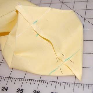 Measure from the tip of the triangle along the stitched line 1 1/4".