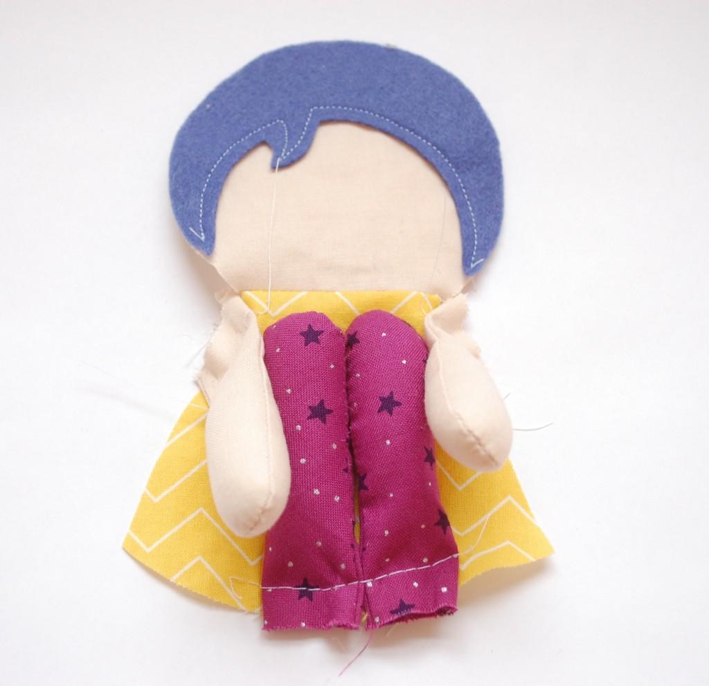 Place the arms on the front of the doll, as marked. Baste. Place the legs on the front of the doll as marked.