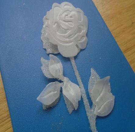 Also cut another rose but add some adhesive sheet over a piece of vellum before cutting the rose out. Add micro beads over the whole of the rose sticky sheet. Step 11.