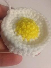 Then using your tapestry needle and white yarn through both side of the egg going around just