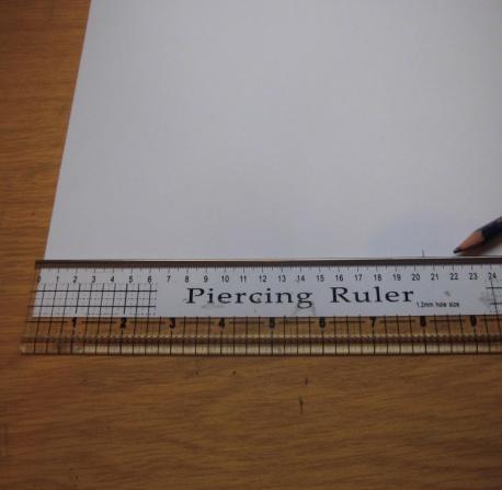 Step 1. Take a piece of 240gsm A3 card stock and mark a measurement of 206mm on the shortest edge.
