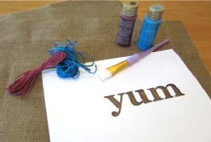YUM Placemats Create a fun table with these casual, rustic placemats made of burlap, decorative cord, and fabric paint.