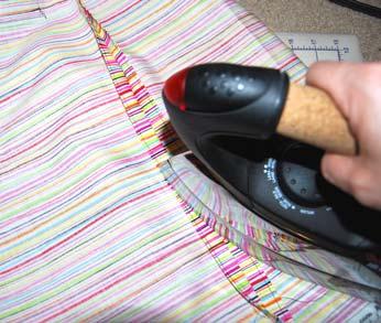 Using a straight stitch, sew the edges of the letter to the bag front only (unfold fabric before stitching). Stitching the Bag 1.