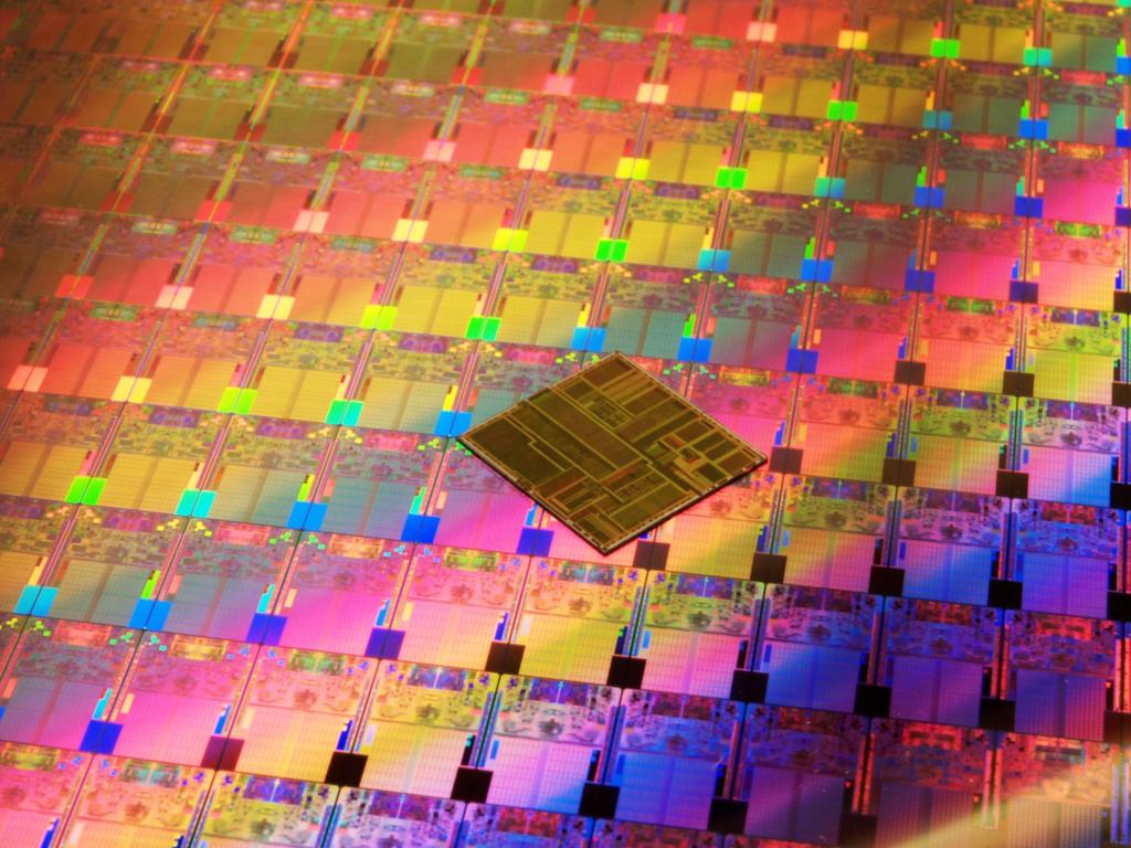 Processors on an Intel 45nm Hafnium-based High-k Metal Gate ''Penryn'' Wafer photographed with an original Intel Pentium processor die.