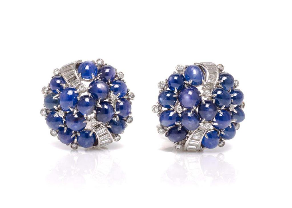 Sale 394 Lot 163 A Pair of Platinum, Sapphire and Diamond Earclips, Raymond Yard, in a bombe cluster design, containing 30 round and oval cabochon cut sapphires weighing approximately 28.