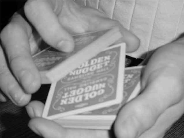 your right hand up. As you do this use your left thumb to push down on the top left corner of the double, beginning to turn the card face up, see Figure 2.
