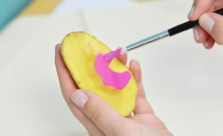 P lace your cut out pattern onto the potato and cut around your chosen shape.