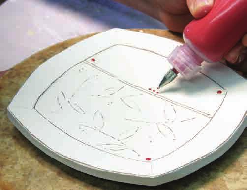 When the plate reaches soft leather hard, flip it over onto its foot and place it onto a small board. Next, place the board on a banding wheel.