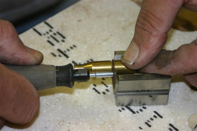 .sanding scars the brass and the A drimmel tool with a cut-off disk can be used. Cut and turn until the brass is cut.