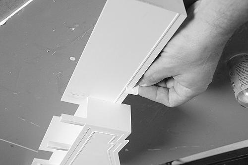 On another piece of cardboard, mount the doors and door frames.