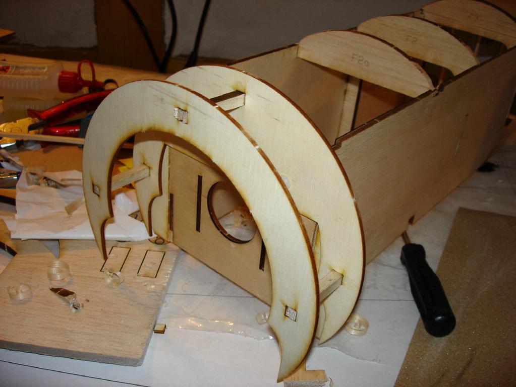 holes in C1 and C2 to align the two-ply semi-rings. Glue three's C3's together with C4 and glue this assembly to the C1/C2 assembly and sand to shape.
