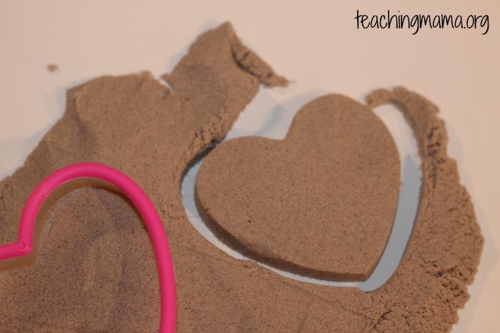 Day 24: Kinetic Sand Kinetic sand (you can buy it or make a homemade version) Play tools (cookie cutters, molds, letters, cars, straws, etc.) Invite your child to play with kinetic sand.