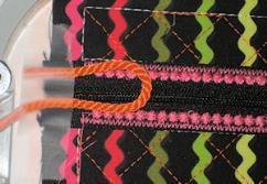 Place the cording with the cut edges outside the tackdown lines, looped end inside the lines. Tape ends in place. Keep the loop at least ½ from the top edge.