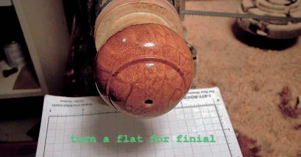 Step 9: Turn a flat area around the hole for the finial, to match the shoulder on the finial as shown in photo #19. Glue the finial in place, using a piece of cork to cushion the tail stock.