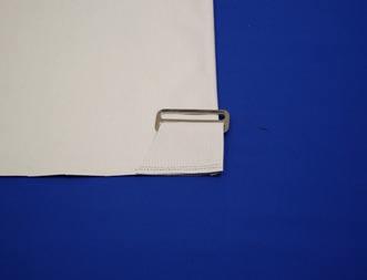 Slip the strap handle piece through a metal strap carrier. Machine-stitch ¼" from ends. Repeat for the second strap handle. c. On the exterior bag fabric, position the strap carriers at opposite ends and opposite sides of the bag.