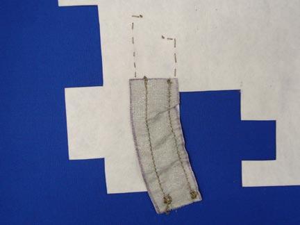Starting ¼" from the left side, using conductive thread, machine-sew a line from the top of the fabric, stopping ¼" from the bottom. Leave 5" of loose thread from the top and bottom.