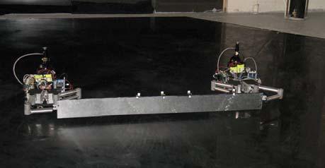 The table is finely leveled to enable the gas bearing supported robots and structural elements to simulate a microgravity environment.