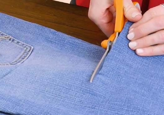 Instructions 1. Cut off the legs of your jeans, but save the scraps to save later.