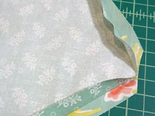 18. Turn the skirt right side out through the top opening. As above, gently push out and square the corners and smooth the curve along the bottom.