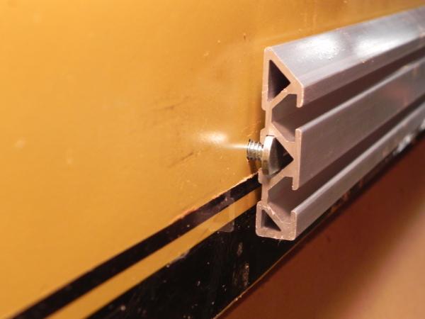 Once the T bolts have been loosely installed, slide the aluminum track onto the T bolts with the angled edge on the top