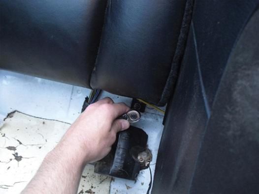 There are two latches, each approximately 1/3 of the way under the seat.