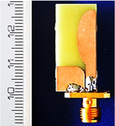 4(b), the current is uniformly distributed over the antenna surface at 7 GHz, which confirms that the antenna radiates. Fig. 7. Photograph of fabricated band notched UWB antenna. (a) (b) Fig. 4.