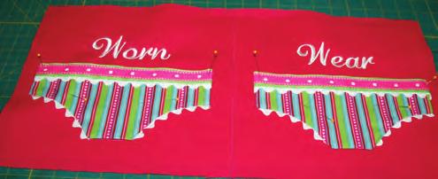 Place a panty applique to the left and right sides of the front piece of embroidered fabric, centering them on