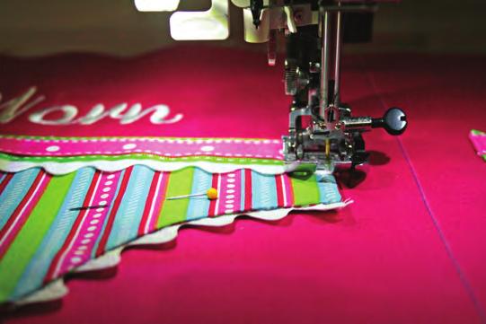 Use a ruler to make sure the applique is perfectly even from the sides and then again from the center line.