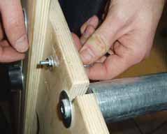 c. Push your machine to the opposite end. d. Tighten the eye bolt until the belt no longer sags in the middle. e. Tighten one full turn of the nut to secure the eye bolt.
