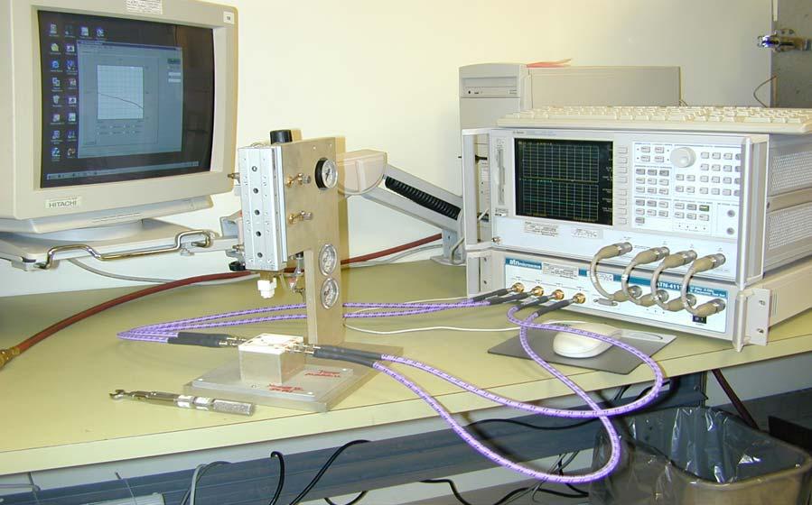 A four port Vector Network Analyzer is connected to the fixture and is used to measure the S-parameters of the part.