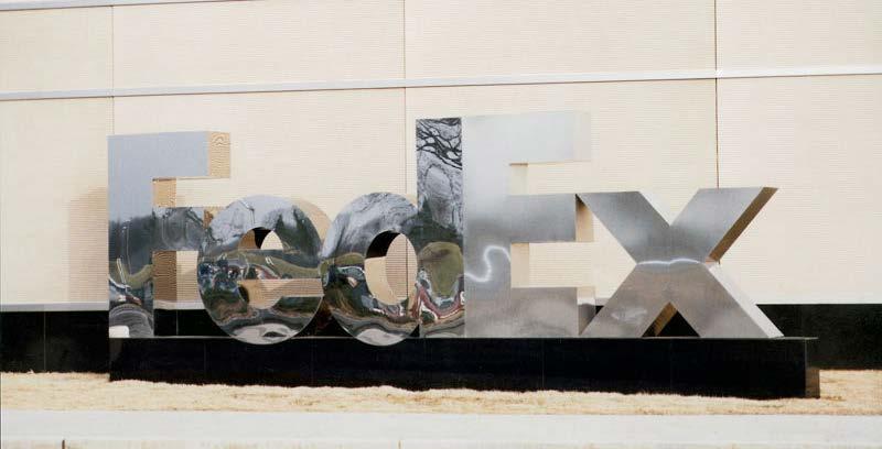 precision cut Bronze Mirror polished bronze logo and letters.