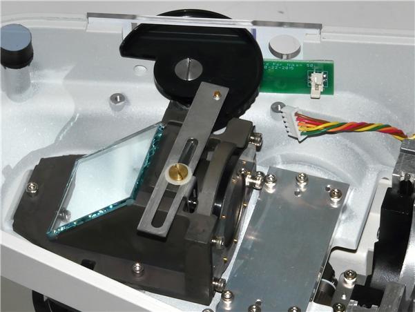 plastic faceplate, and firmly press the adhesive against the microscope.