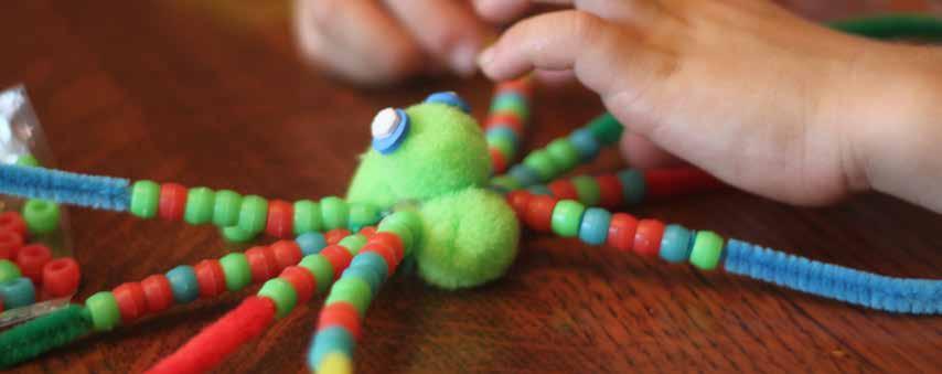 Beaded Spider 4 pipe cleaners beads pom poms string scissors Take 4 pipe cleaners and lay them straight out, together.
