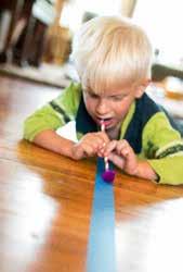 Blow a pom pom along the line, gently trying to keep it on the line of tape. Young kids and old, love this activity. Its great for balance and coordination.
