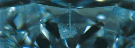 Laser drilling A diamond with a prominent black included crystal may be drilled with a laser.