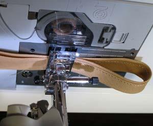 Sew the strip together at the marks. Add the loop in the tape to the lower seam on the mitt.