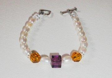 Option 3 - A single strand design with one or more kid's birthstone beads strung in the center of the bracelet.