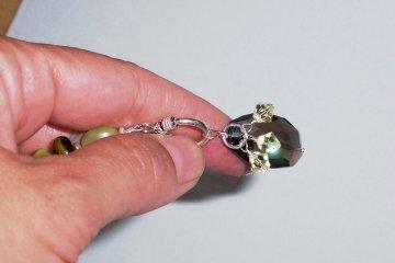 Before closing the loop, attach the jumpring with crystals, and attach the entire beaded charm to the round part of your toggle clasp so it slides freely.