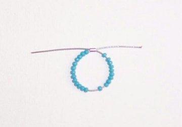 Step 3 Make and attach the turquoise and pearl sliding charm Slide seed beads onto a short length of flexible beading wire until you complete a circle with a