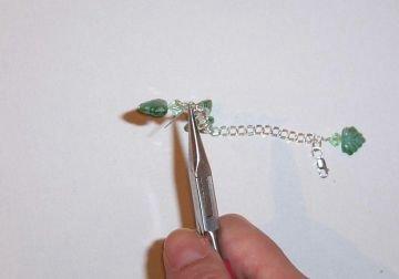 Step 3 Attach beads and charms Now attach each charm by looping it through a link in the