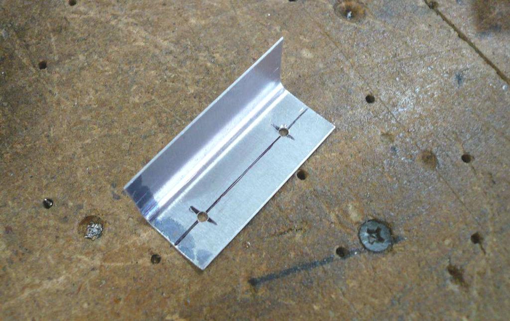Cut two L Angles 50mm long. Draw a center line on one flange of the L Angle. Mark rivet locations 10mm from each end of the L Angle.
